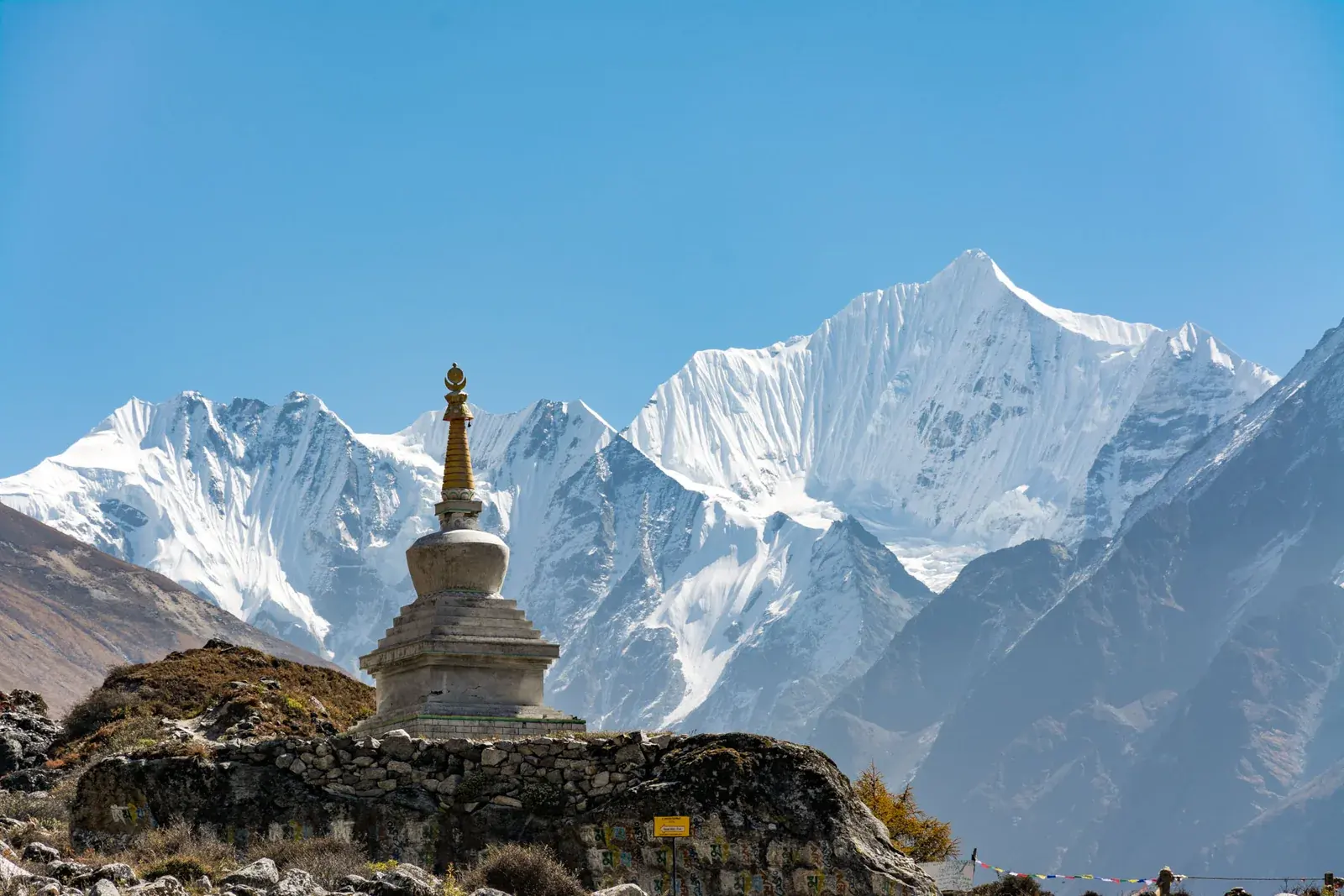 Chorten below snow peaks at Kyanjin Gompa, Langtang
